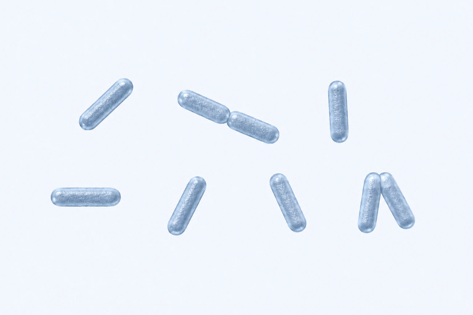 Nine rounded-end Proteus rods appear in seven groups: five isolated singles and two touching pairs on a pale field.